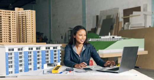 smiling-african-american-lady-with-laptop-model-building
