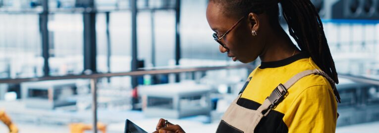 Smart factory engineer implements automated workflows using artificial intelligence tech, computerizing manual operations. Woman integrates sensors into production using AI technology, camera A